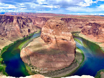 Aerial view of rock formations against cloudy sky