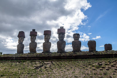 Low angle view of statues against sky