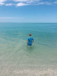 Man standing on beach against sky