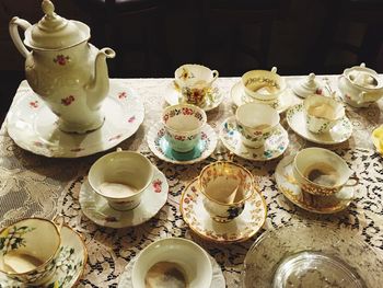 High angle view of teapot and cups on table