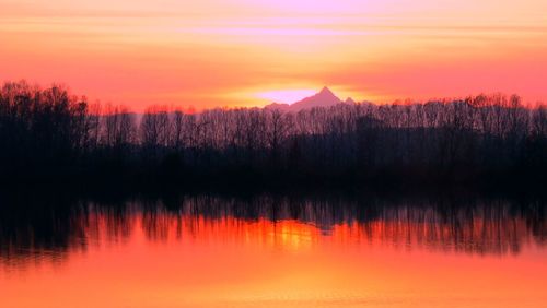 Scenic view of lake against romantic sky at sunset