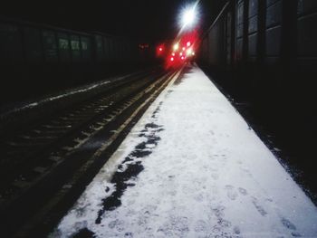 Illuminated road at night during winter