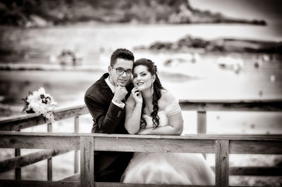 Portrait of young couple sitting outdoors