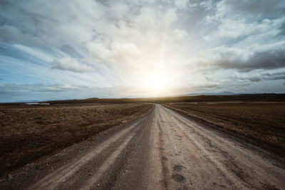 Empty road along countryside landscape