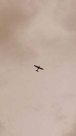 Low angle view of airplane flying in sky