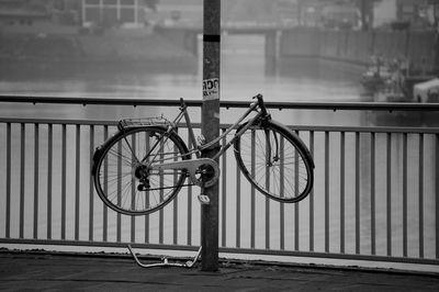 Broken bicycle tied to pole