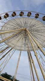 Low angle view of ferris wheel against sky