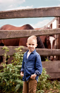 Portrait of boy standing outdoors