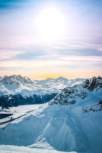 Scenic view of snowcapped mountains against sky during sunset