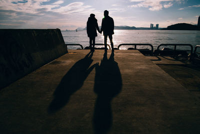 Shadow of men on silhouette man against sky