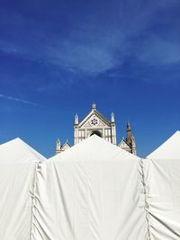 Low angle view of white church against blue sky