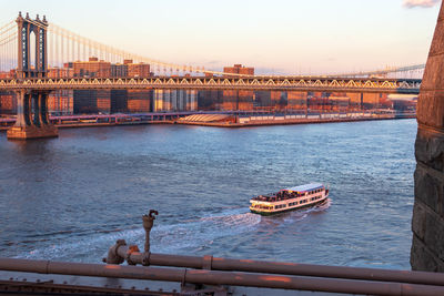 View of bridge over river at sunset