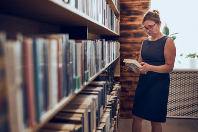 Woman reading book in public library. reading and learning. benefits of everyday reading. bookstore