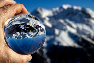 Cropped image of person holding crystal ball