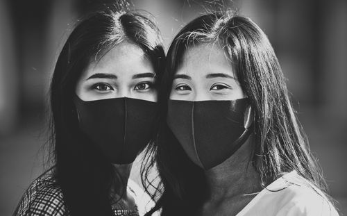 Close-up portrait of friends wearing mask