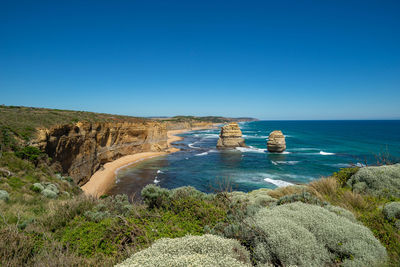 Scenic view of sea against clear blue sky