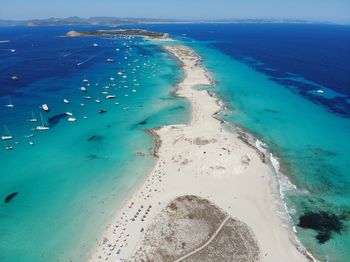 Aerial view of sea shore against blue sky