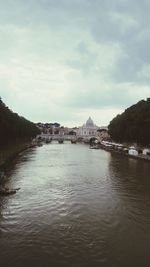 View of bridge over river against cloudy sky