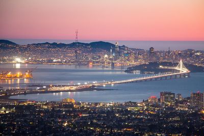 High angle view of city lit up at night