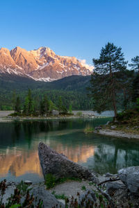 Scenic view of lake by mountains against sky