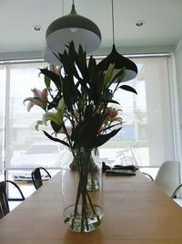 Flower vase on table at home