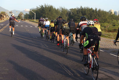 People riding bicycles on road