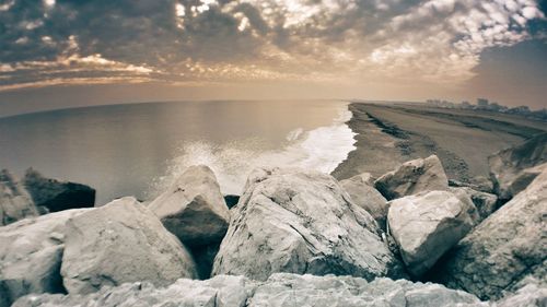 Scenic view of sea against cloudy sky