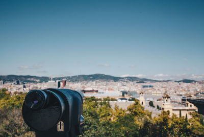 Coin operated binoculars against blue sky