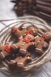 Close-up of gingerbread cookies with threads on table