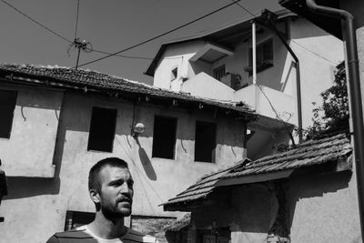 Low angle portrait of man against building