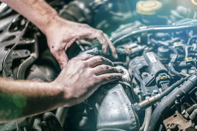 Midsection of man working in car