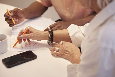 View of coworkers hands during business meeting