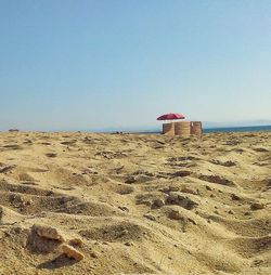 Lifeguard hut on beach against clear sky