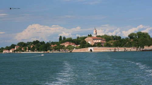 Scenic view of sea and buildings against sky