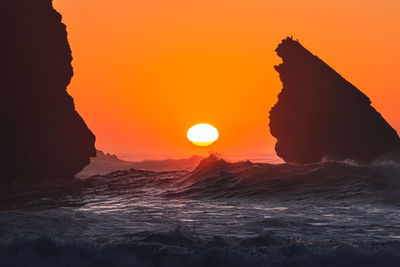 Scenic view of sea against orange sky