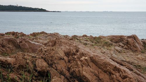 Scenic view of rocks in sea against sky