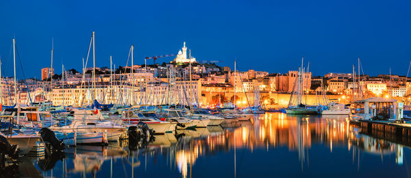 Boats moored at harbor