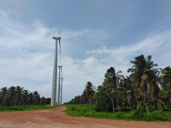 A row of tall industrial windmills