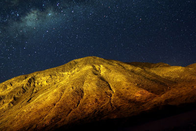 Scenic view of landscape against sky at night