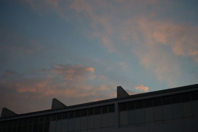 Low angle view of silhouette house against sky during sunset