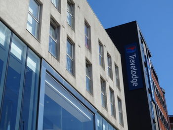 Low angle view of building against clear blue sky