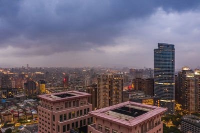 High angle view of buildings in city against sky