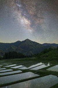 Scenic view of field against sky at night