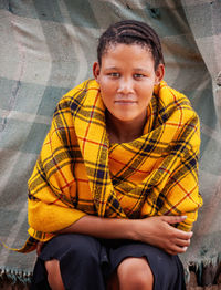 Portrait of teenage boy sitting outdoors