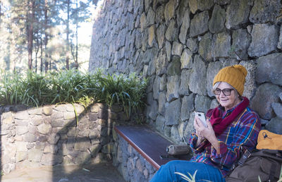 Portrait of smiling young man sitting outdoors