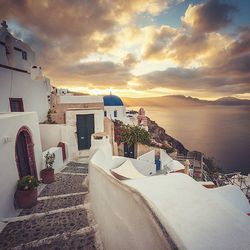 Houses in oia at santorini against sky during sunset