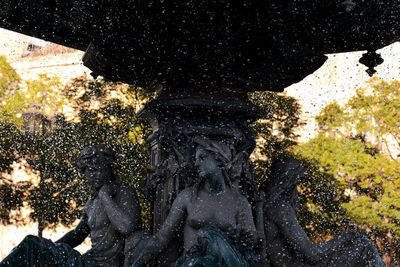 Statue by trees against clear sky