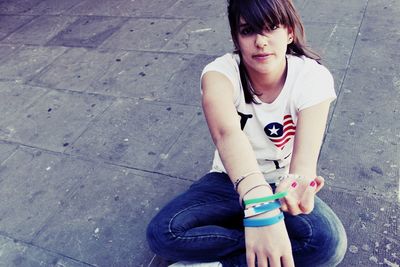 High angle portrait of woman sitting outdoors