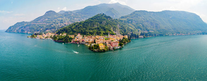 Panoramic view of sea and mountains against sky