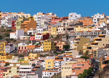 Buildings in city against clear sky